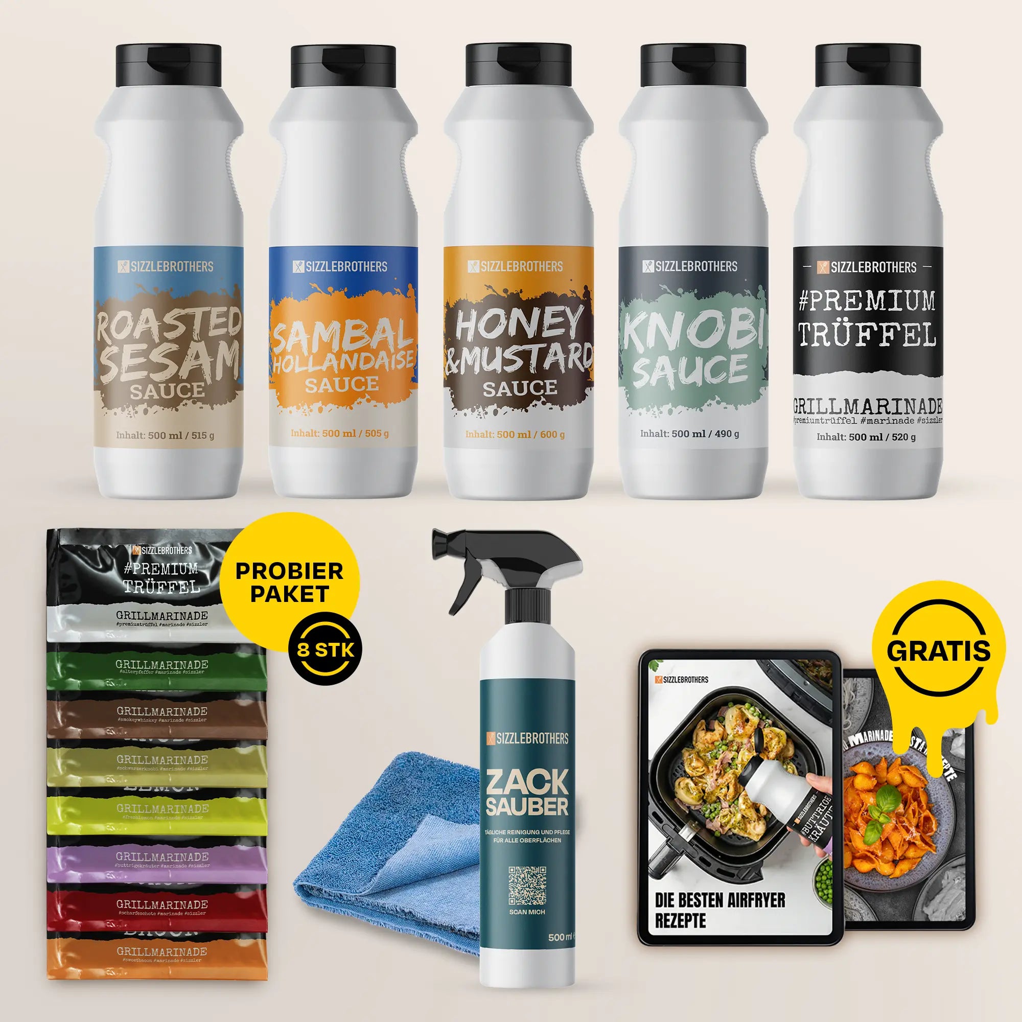 FĂĽnf Saucenflaschen, Probierpaket mit acht Saucen, Reinigungsspray, Tuch, und Rezeptbuch.