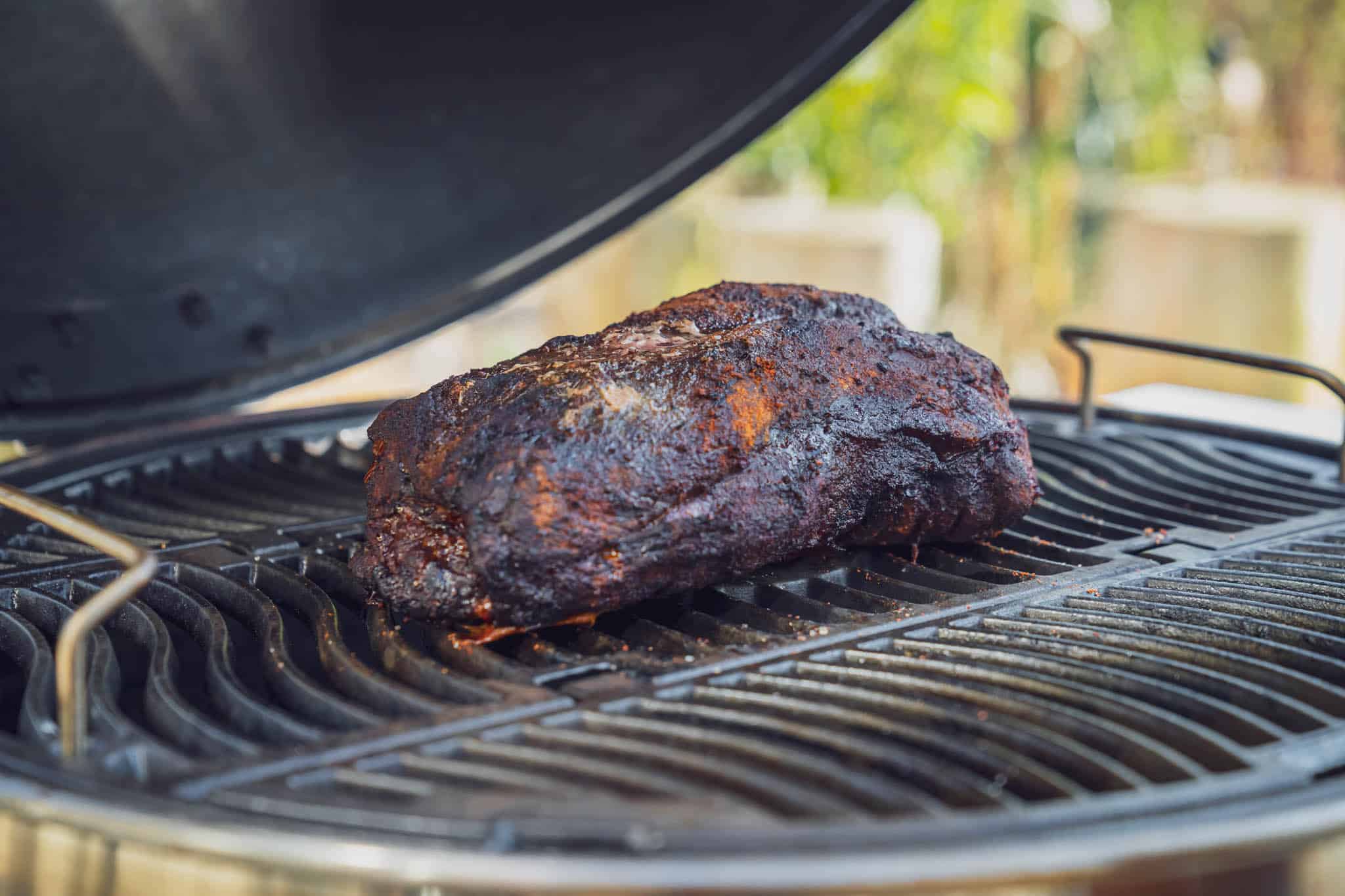 Gebräuntes Fleischstück auf offenem Grill.