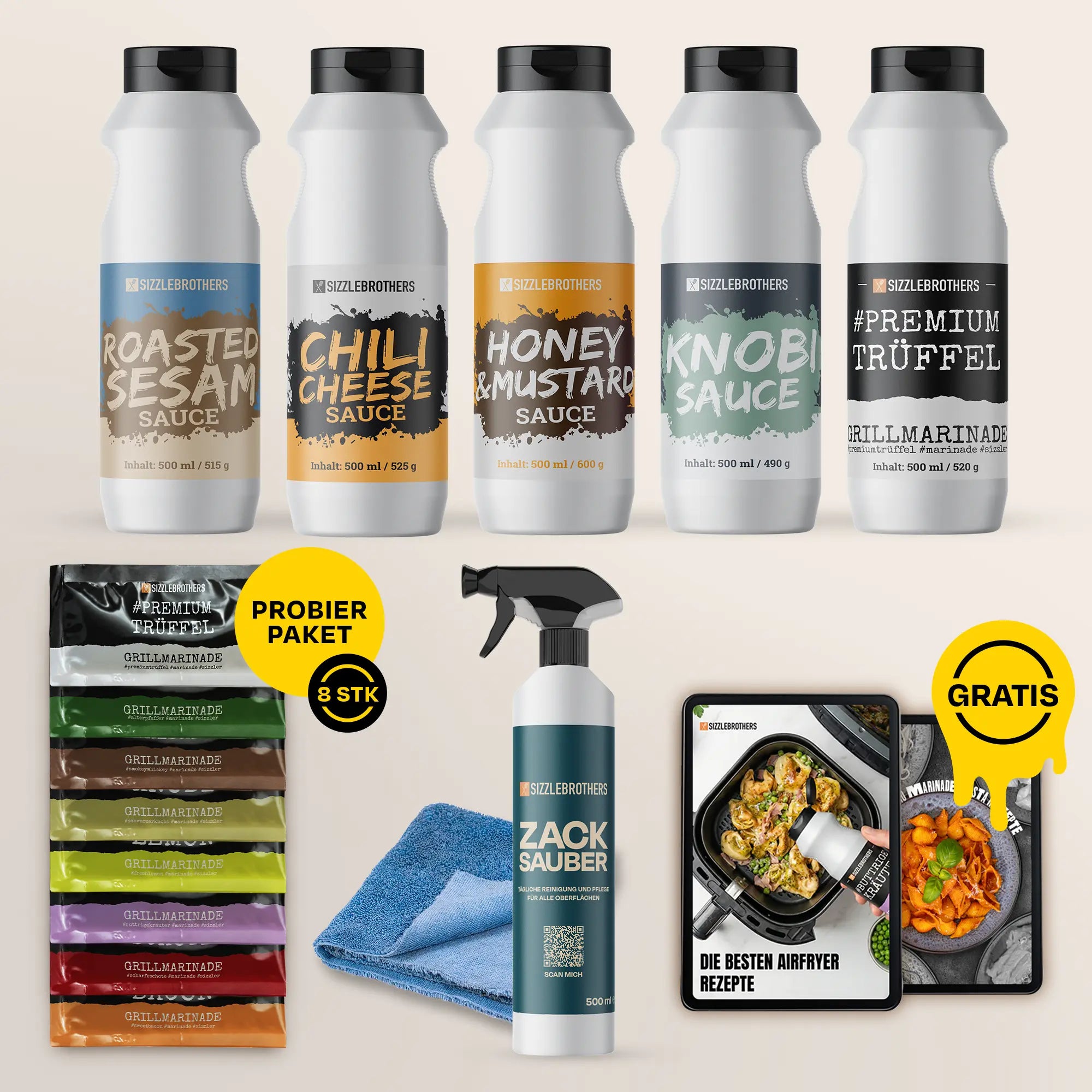 Fünf weiße Saucenflaschen, sechs Marinaden, ein Spray und ein Rezeptbuch mit „GRATIS“-Sticker.