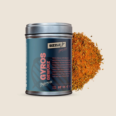 Dose Gyros-Gewürz neben einer Portion des Gewürzes auf hellbeigem Hintergrund.